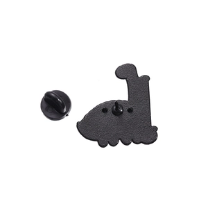 Detailed back view of enamel dinosaur pin with textured metal finish and rubber clutch