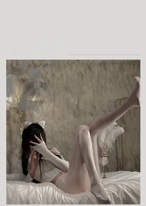 Close-up of shiny white oil stockings with off-shoulder knit top and cat ear headband