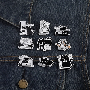 Macro view of nine cute enamel cat pins with funny quotes on blue denim fabric