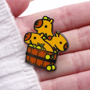 Macro view of a cute capybara enamel pin set in a bath barrel with citrus details