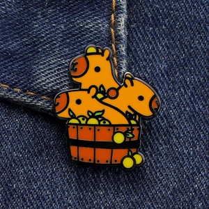 Detail of creative capybara enamel pin in wooden bath tub on denim background