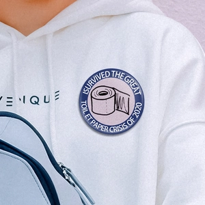 Badge amusant 'I Survived Toilet Paper Crisis 2020' en fer-blanc sur un sweat blanc