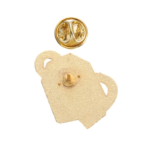 Detailed back view of golden metal omamori badge with secure butterfly clutch pin backing