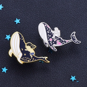 Galaxy Whale Enamel Pins featuring a sleeping girl and astronaut on a cosmic ocean theme