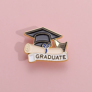 Detailed view of alloy enamel brooch with black graduation cap and scroll
