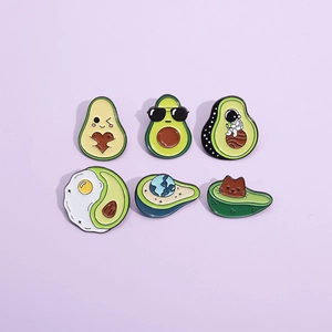 Cute avocado enamel pin set featuring astronaut and cat designs on light purple background