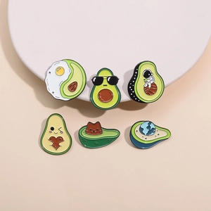 Detailed close-up of six creative avocado enamel pins featuring cute cats and astronauts