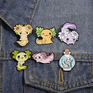 Cute cartoon axolotl enamel pin set featuring floral and bottle designs on denim jacket