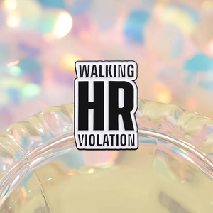 Macro shot of rectangular enamel pin featuring Walking HR Violation slogan text