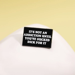 Creative black enamel pin badge with white sarcastic lettering on minimalist background