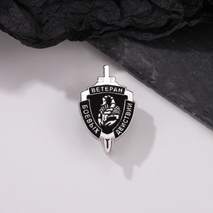 Detailed macro of a black alloy military badge featuring a scorpion and Russian text