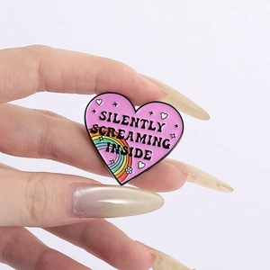 Cartoon heart enamel pin with rainbow and Silently Screaming Inside quote for backpacks