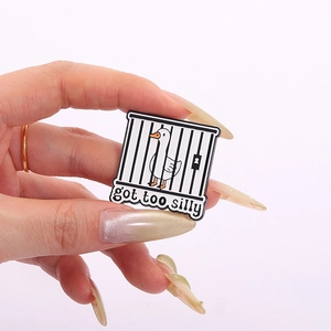 Funny cartoon goose enamel pin with 'got too silly' text in black cage design