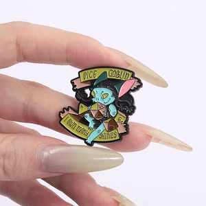 Cartoon Dice Goblin enamel pin with I Own Many Shinies text on white background