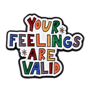 Detail of enamel badge with Your Feelings Are Valid text and colorful lettering