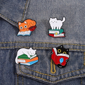 Cute Japanese cartoon cat enamel pins set featuring kittens reading books on denim fabric