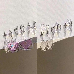 Macro detail of Y2K star and pink heart earring set with polished silver finish