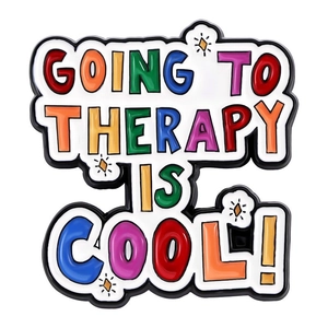 Detailed macro view of colorful Going to Therapy is Cool enamel pin with star motifs