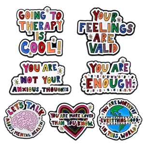 Set of 7 colorful enamel pins featuring mental health themes and inspiring English quotes