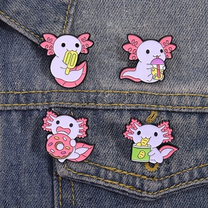 Set of four cute purple axolotl enamel pins featuring snacks on blue denim fabric
