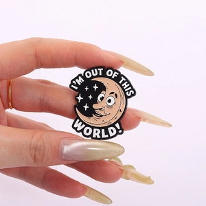 Cartoon enamel pin featuring a smiling moon and stars with I'm Out Of This World text