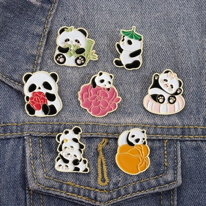 Cute cartoon panda enamel pins set featuring bamboo eating panda on blue denim jacket