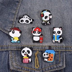 Set of seven cute cartoon panda enamel pins on blue denim, featuring various fun panda poses