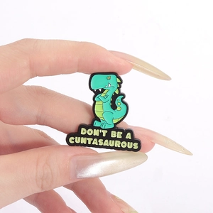 Funny green dinosaur enamel pin with Don't Be A Cuntasaurous quote for denim jackets