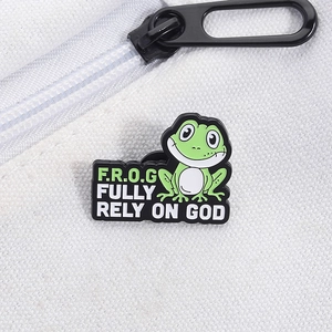 Detail of frog enamel pin on canvas bag featuring Fully Rely On God inspirational text