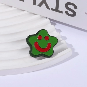Cartoon star-shaped enamel brooch pin with green finish and red smiley face design