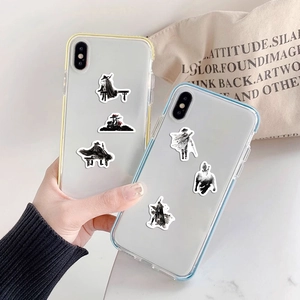 Detail of transparent phone cases featuring black and white ink wash samurai art designs