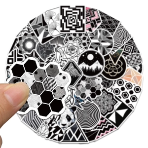 Close-up of monochrome geometric stickers with panda and mountain designs on white background