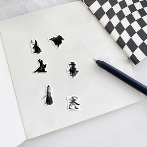 Macro view of oriental ink silhouette martial arts stickers on a white notebook
