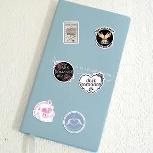 Detailed view of Dark Romance stickers applied to a blue notebook for DIY decoration