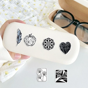 Detail of geometric monochrome stickers applied to an eyewear case for creative decoration