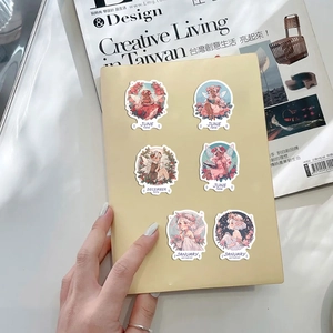 Set of floral fairy stickers featuring monthly botanical watercolor designs on a notebook