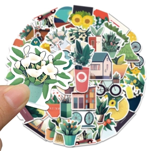 Detailed close-up of a hand holding a floral plant sticker from a flat-style creative set
