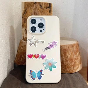 Close-up of Y2K aesthetic hair clips featuring stars and hearts on a phone case back
