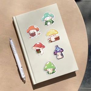 Detail of cute mushroom stickers with unique expressions on a mint green notebook cover