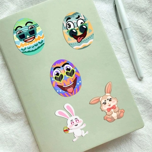 Easter bunny and colorful egg stickers on a green notebook for DIY crafts and activities