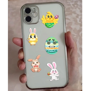 Close-up of clear iPhone case featuring colorful Easter bunny and egg cartoon prints