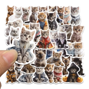 Close-up of a hand holding a cute cartoon cat sticker with waterproof matte finish