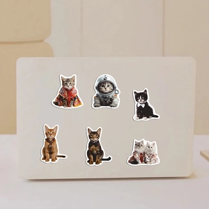 6-pack cute realistic cat stickers with diverse outfits on a white laptop back cover