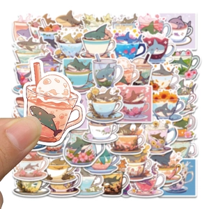 Detailed view of cute shark stickers with a hand holding a piece showing print quality