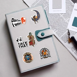 50pcs waterproof welding worker graffiti stickers set on a grey leather notebook surface