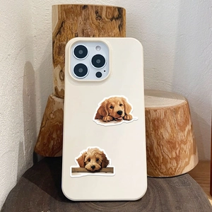 Detail of cream white silicone phone case featuring cute golden retriever and poodle patterns