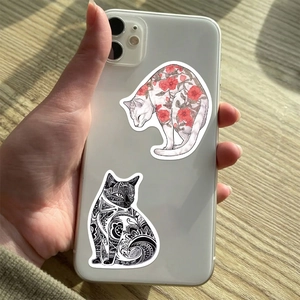 Cute Japanese style cartoon cat stickers with floral and tribal patterns on a wood desk
