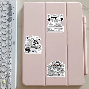 Black and white cartoon couple stickers shown decorating a pink tablet case with stationery