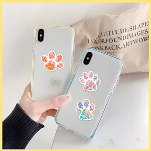 Detail of transparent iPhone case with colorful floral and camo paw print patterns