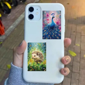 Vibrant galaxy animal art stickers featuring a peacock and hedgehog on a white phone case